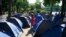 A volunteer from Doctors Without Borders takes notes on migrants who set up tents along a canal in Paris, May 27, 2020. 