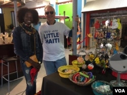 Vendor Aura Bond and author, tour guide David C. Brown in front of Aura's stand at the Caribbean Marketplace in Little Haiti, Miami, Florida. (Photo: S. Lemaire /VOA)