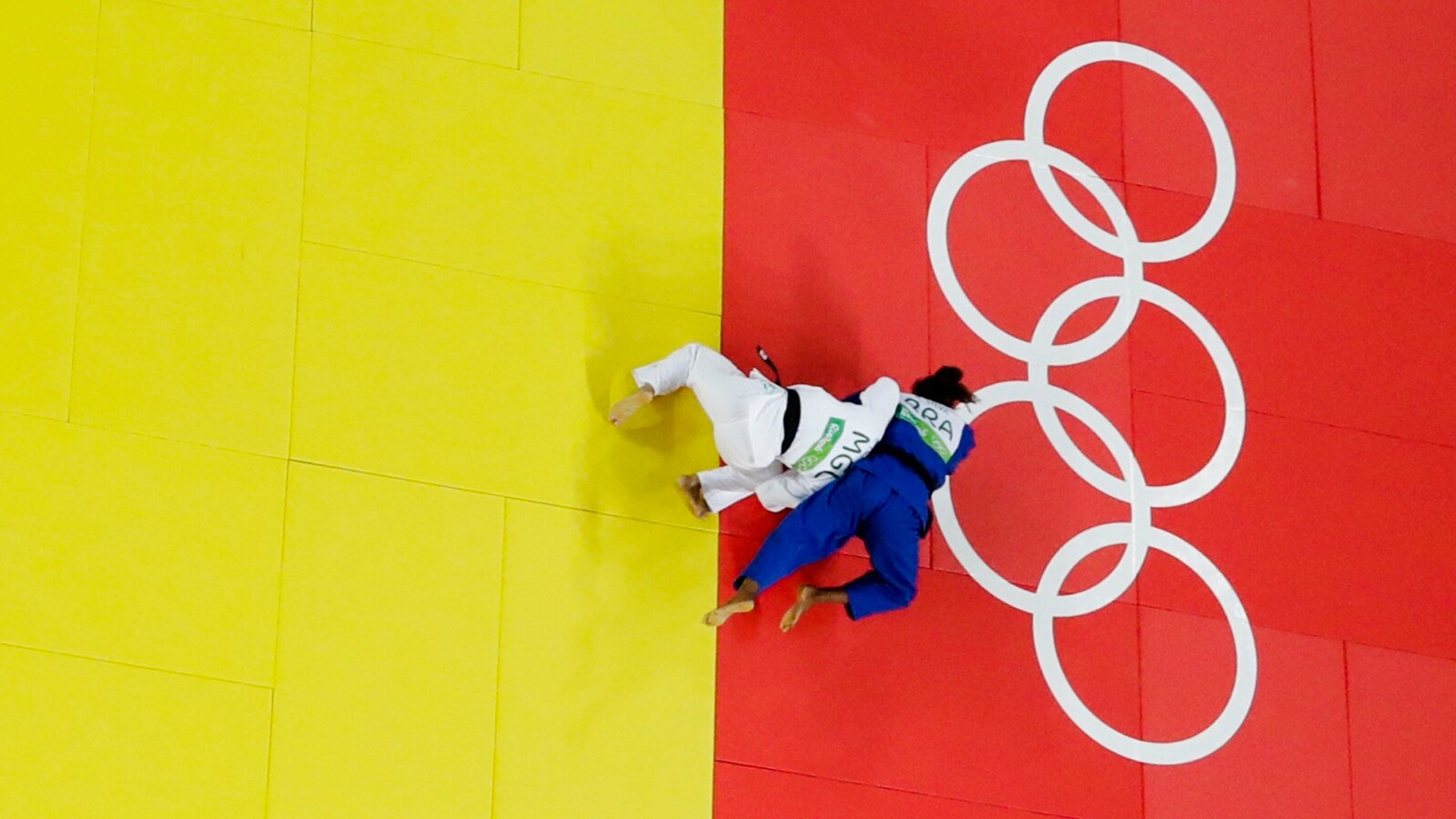 Brazil's Rafaela Silva, blue, and Mongolia's Sumiya Dorjsuren compete during the final of the women's 57 kg judo competition at the 2016 Summer Olympics in Rio de Janeiro, Brazil, Aug. 8, 2016. 