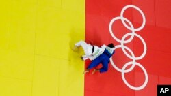 Brazil's Rafaela Silva, blue, and Mongolia's Sumiya Dorjsuren compete during the final of the women's 57 kg judo competition at the 2016 Summer Olympics in Rio de Janeiro, Brazil, Aug. 8, 2016. 