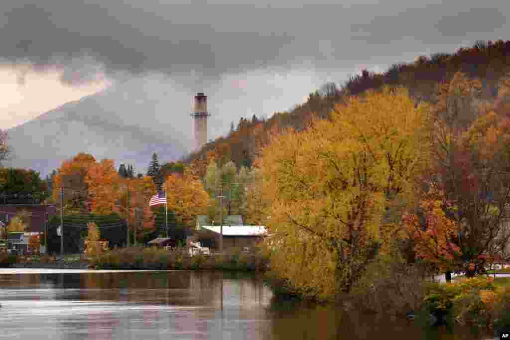 Fall foliage adds color to a rainy day along the Androscoggin River in Berlin, New Hampshire.&nbsp;