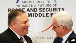 Poland's Minister of Foreign Affairs Jacek Czaputowicz, right and U.S. Secretary of State Mike Pompeo shake hands at the end of a conference on promoting security in the Middle East that Poland co-hosted with the United States, in Warsaw, Feb. 14, 2019.