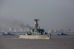 FILE - A Myanmar navy vessel takes part in a celebration to mark the navy's 72nd anniversary in Yangon, Dec. 24, 2019.