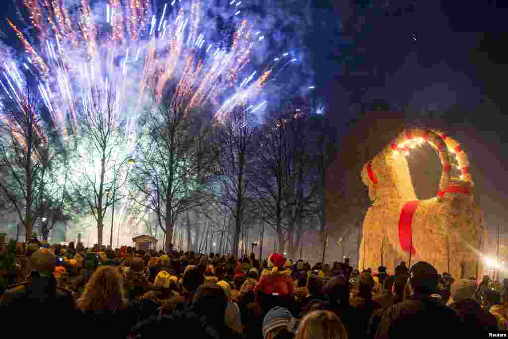 People gather at the inauguration of the Gavlebocken (Gavle Goat), which is a traditionally Christmas display, at Slottstorget (Castle Square) in central Gavle, Sweden.