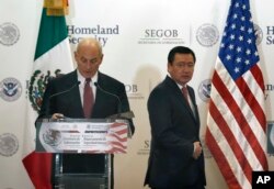 U.S. Homeland Security Secretary John Kelly, left, and Mexico's Interior Secretary Miguel Angel Osorio Chong arrive for a press conference in Mexico City, July 7, 2017.