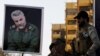 FILE - Members of the mainly Shi'ite Hashid Shaabi militia hold a portrait of Quds Force Commander Qassem Suleimani during a demonstration to show support for Yemen's Shi'ite Houthis and in protest of an air campaign in Yemen by a Saudi-led coalition, in 