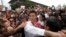 Thailand's Future Forward Party leader Thanathorn Juangroongruangkit, center, is mobbed by his supporters upon arrival at a police station Bangkok, Thailand, April 6, 2019. 