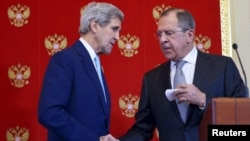 FILE - U.S. Secretary of State John Kerry (L) and Russia's Foreign Minister Sergei Lavrov shake hands during a joint news conference at the Kremlin in Moscow, Dec. 15, 2015. 