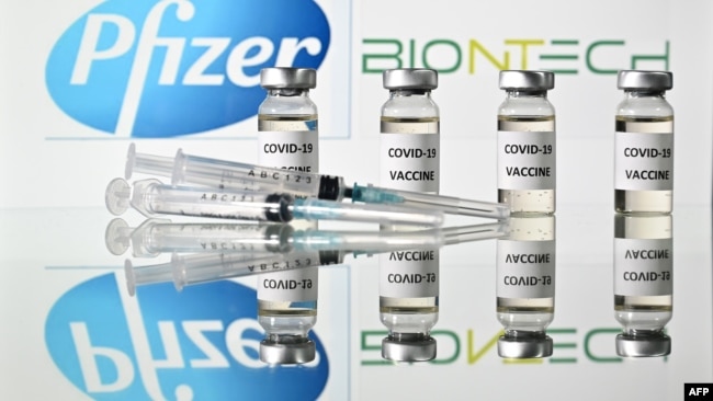 An illustration picture shows vials with Covid-19 vaccine stickers with the logo of US drug-maker Pfizer and German partner BioNTech, on November 17, 2020. (Photo by JUSTIN TALLIS / AFP)