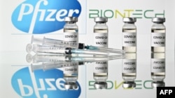 An illustration picture shows vials with Covid-19 vaccine stickers with the logo of US drug-maker Pfizer and German partner BioNTech, on November 17, 2020. (Photo by JUSTIN TALLIS / AFP)