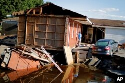 Part of the Starlite Motel is washed away in the aftermath of flooding from Hurricane Florence in Spring Lake, N.C., Sept. 19, 2018.