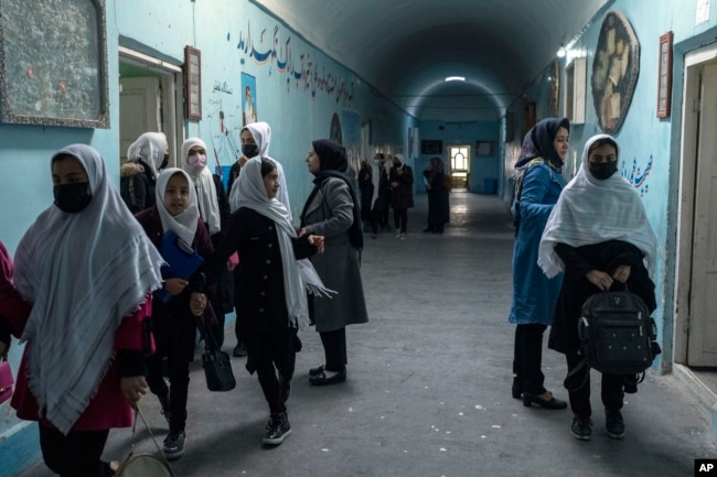 Afghan girls exit classrooms at Tajrobawai Girls High School, in Herat, Afghanistan, Nov. 25, 2021.