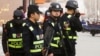 FILE - Armed police keep watch in a street in Kashgar, Xinjiang Uighur Autonomous Region, China, March 24, 2017. 