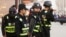 FILE - Armed police keep watch in a street in Kashgar, Xinjiang Uighur Autonomous Region, China, March 24, 2017. 