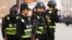 FILE - Armed police keep watch in a street in Kashgar, Xinjiang Uighur Autonomous Region, China, March 24, 2017. 
