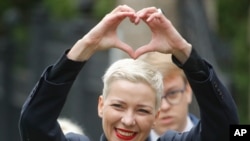 Maria Kolesnikova, one of Belarus' opposition leaders, gestures on the way to the Belarusian Investigative Committee in Minsk, Belarus, Aug. 27, 2020.