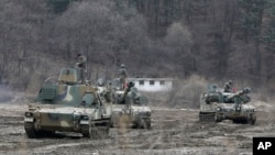 South Korean army soldiers on motorized artillery take part in this year's joint military exercises in Paju near the border with North Korea. Tensions are especially high this year because of North Korea's response to U.N. Security Council sanctions put in place because of the North's nuclear and missile tests.