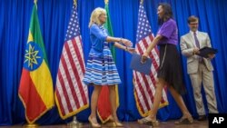 Jill Biden, left, greets a graduate on stage at the Girls Can Code project graduation ceremony at the Colonel John C. Robinson American Center at the National Archive and Library Agency (NALA), in Addis Ababa, Ethiopia, July 17, 2016. 