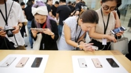 2018年9月21日，上海的苹果公司办公室对媒体展示新产品，人们体验新的Apple iPhone XS和iPhone XS Max。