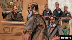 FILE - Khalid al-Fawwaz is seen with fellow terror suspect Adel Abdul Bary, seated, in this sketch made during an appearance in Manhattan Federal Court in New York, Oct. 6, 2012.