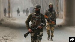 FILE - Indian soldiers block a road near the site of a gun battle at Arwani, 55 kilometers (34 miles) south of Srinagar, Indian-controlled Kashmir, Dec. 8, 2016.