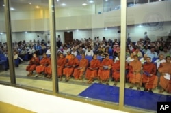 Buddhist monks and other people sit at the Extraordinary Chambers in the Courts of Cambodia (ECCC) on the outskirts of Phnom Penh, June 27, 2011.