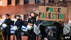 Seorang demonstran pendukung Palestina memegang poster bertuliskan, "Bebaskan Palestina", dalam aksi solidaritas dengan Gaza yang digelar di Duisburg, Jerman, pada 9 Oktober 2023. (Foto: AFP/Ina Fassbender)