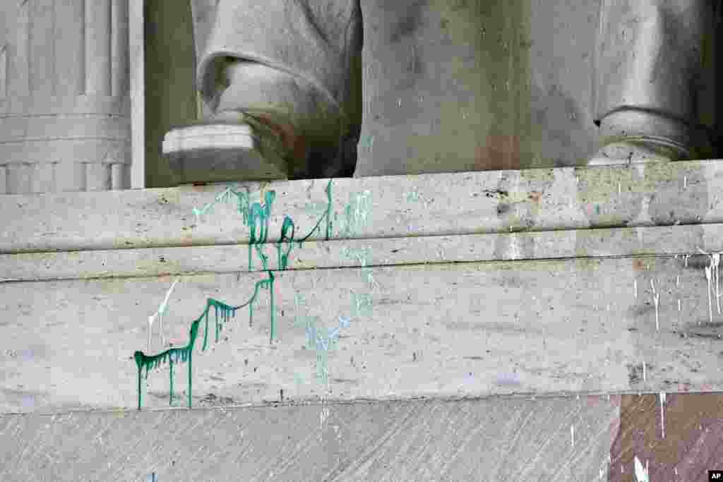 Green paint is splattered on the base of the statue of Abraham Lincoln at the Lincoln Memorial in Washington, July 26, 2013.