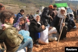 Internally displaced Syrians fleeing advancing pro-government forces wait near the Syrian-Turkish border after they were given permission by the Turkish authorities to enter Turkey, in Khirbet Al-Joz, Latakia countryside, Feb. 2, 2016.