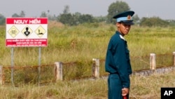 Seorang tentara Vietnam berdiri di dekat lokasi pada Perang Vietnam yang digunakan untuk menyimpan bahan kimia yang sangat berbahaya, “agen oranye.” (foto: ilustrasi). 