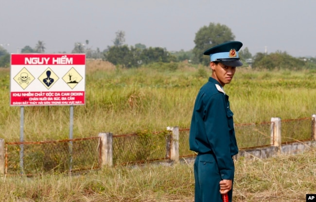 FILE - A Vietnamese soldier stands guard at the dioxin contaminated area while U.S. Defense Secretary Jim Mattis visits Bien Hoa air base in Bien Hoa, outside Ho Chi Minh City, Vietnam, Oct. 17, 2018. (Kham/Pool Photo via AP)