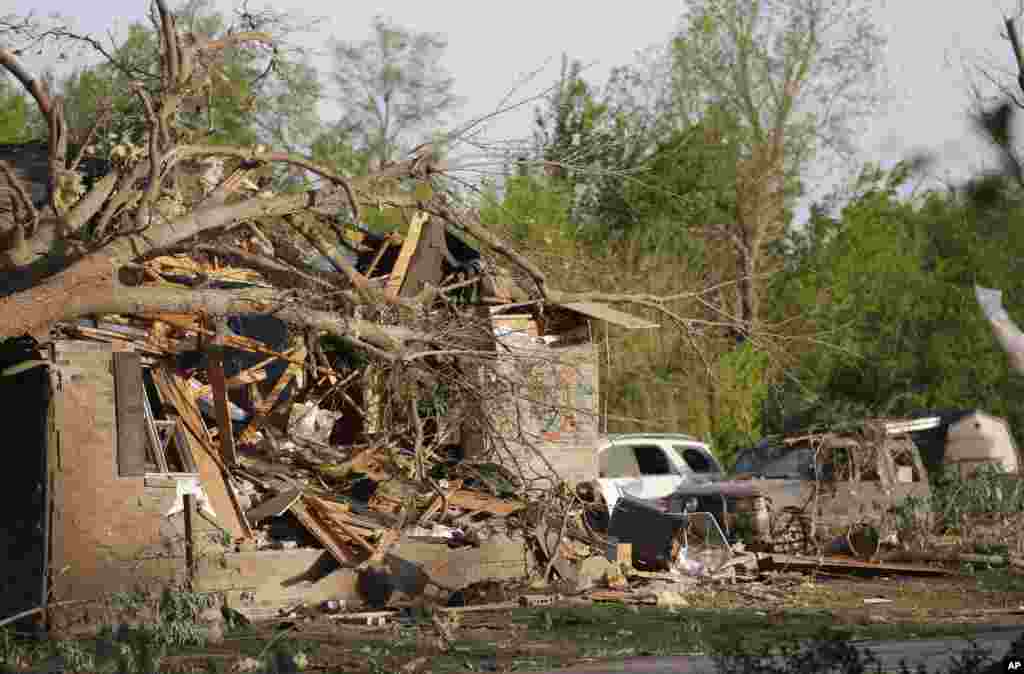 A tornado-damaged home awaits cleanup and repairs after a tornado hit the region, Baxter Springs, Kansas, April 28, 2014.
