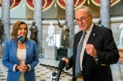 Senate Minority Leader Chuck Schumer of New York, with House Speaker Nancy Pelosi of California, speaks to reporters following a meeting at the Capitol on a COVID-19 relief bill, Aug. 1, 2020, in Washington.
