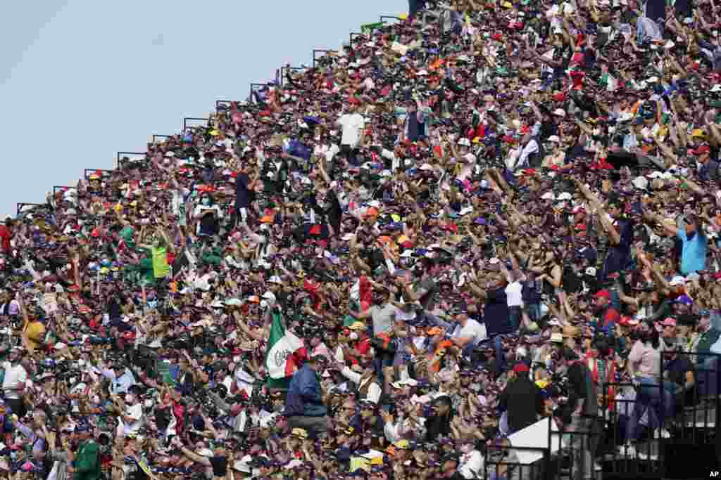 Fans cheers in the stands during the qualifying run of the Formula One Mexico Grand Prix auto race at the Hermanos Rodriguez racetrack in Mexico City, Nov. 6, 2021.