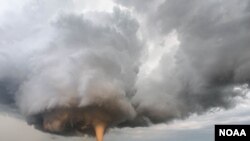 A Tornado Churns Up Dust In Sunset Light Near Traer, Iowa. Second place, “Professional Submission” by Brad Goddard, from NOAA's Weather in Focus photography contest.