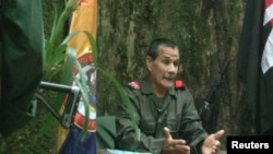 FILE - Colombian guerrilla group National Liberation Army (ELN) commander Nicolas Rodriguez, known as "Gabino," gestures as he speaks in response to questions from Reuters at a hidden jungle camp in this still image taken from an undated video released Aug. 27, 2012. 
