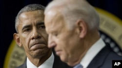 President Barack Obama listens to Vice President Joe Biden make remarks before signing the 21st Century Cures Act in Washington, D.C., Dec 13, 2016.