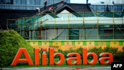 FILE - Workers renovate a building at the Alibaba head office in Hangzhou, east China's Zhejiang province, Sept. 15, 2014. 