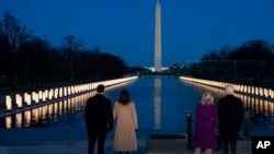 President-elect Joe Biden and his wife Jill Biden are joined by Vice President-elect Kamala Harris and her husband Doug Emhoff in a COVID-19 memorial event at the Lincoln Memorial Reflecting Pool, in Washington, Jan. 19, 2021.