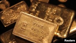 FILE - Gold bars are displayed at a gold jewelry shop in the northern Indian city of Chandigarh. 