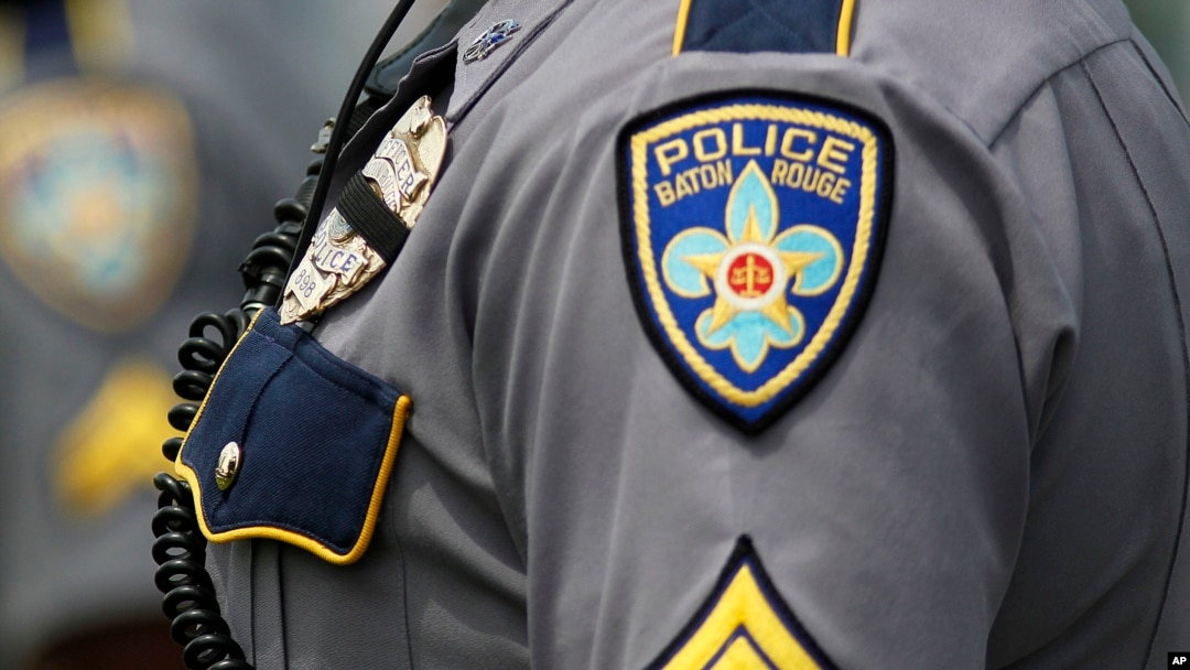 FILE - A Baton Rouge, La. motorcycle police officers stands at attention.