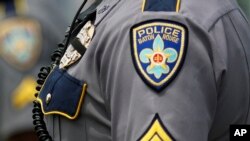 FILE - A Baton Rouge, La. motorcycle police officers stands at attention.