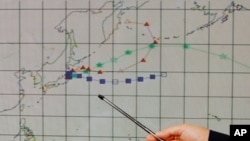 An officer at the Hong Kong Observatory shows a forecast trajectory of radiation releases from Japan during a news conference in Hong Kong, March 15, 2011