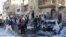 Residents gather at the site of a car bomb attack in the Hurriya district in Baghdad, January 10, 2013.