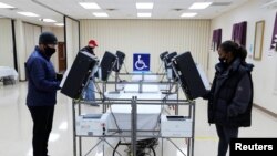 Voters cast their ballots in the U.S. Senate run-off election, at a polling station in Marietta, Georgia, Jan. 5, 2021. 