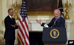 Vice President Joe Biden, right, speaks as President Barack Obama, left, listens, during a ceremony in the State Dining Room of the White House in Washington, Thursday, Jan. 12, 2017.