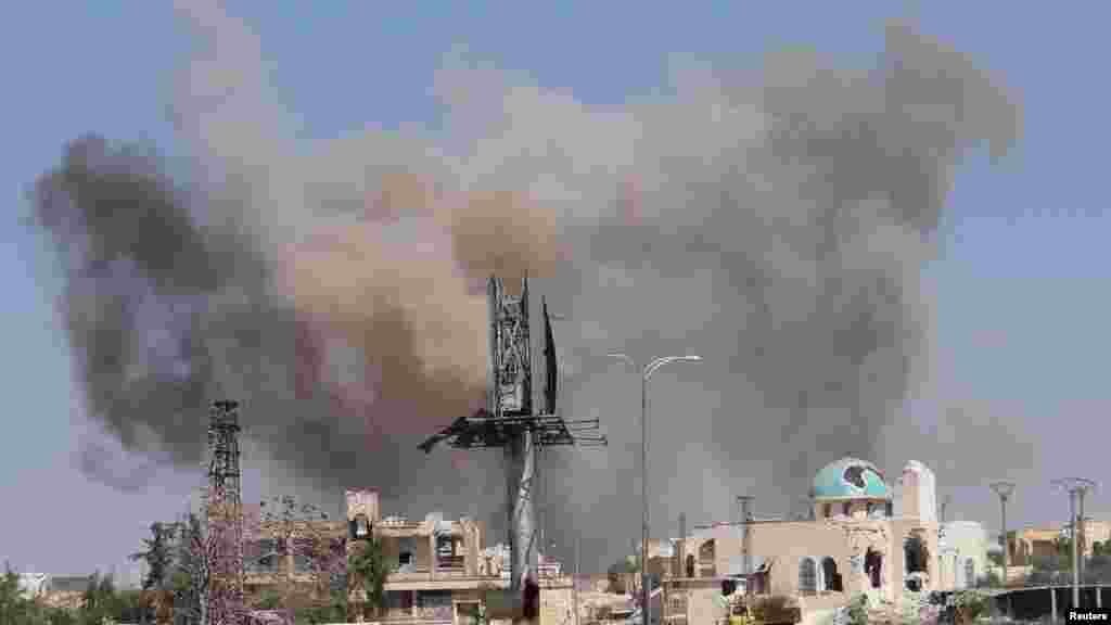 Smoke rises after what activists said was an airstrike by forces loyal to Syria's President Bashar al-Assad in Blleramoon district at the northern entrance to the city of Aleppo, March 23, 2014. 