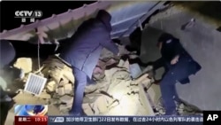 In this image taken from video footage run by China's CCTV, rescuers work near the rubble from an earthquake in Kizilsu Kirghiz Autonomous Prefecture, China’s western Xinjiang region, Jan. 23, 2024. 