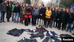 Academics lay down their gowns during a protest against the dismissal of academics from universities following a post-coup emergency decree, in the Cebeci campus of Ankara University in Turkey, Feb. 10, 2017.