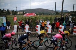 Spectators take pictures of the pack during the first stage of the Tour de France cycling race in France, Aug. 29, 2020.